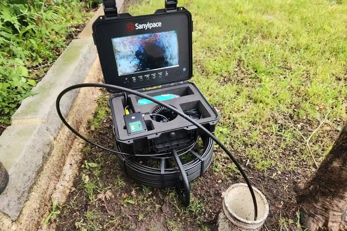 Drain camera monitor showing the inside of a clogged sewer pipe