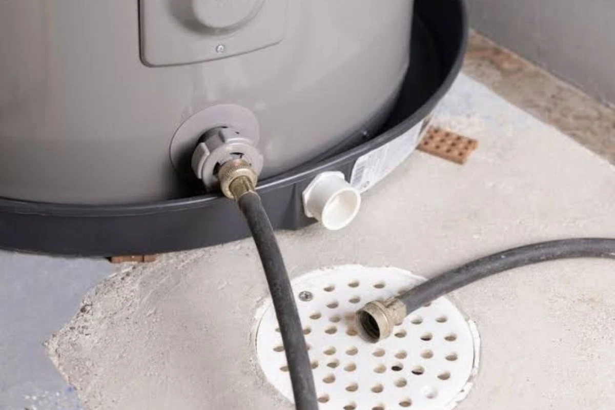 Rust and moisture at the base of a failing tank water heater